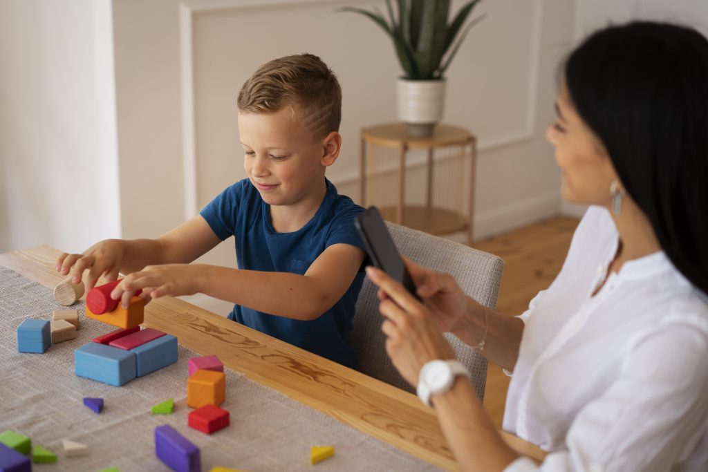 boy and mon playing with brain teaser toy