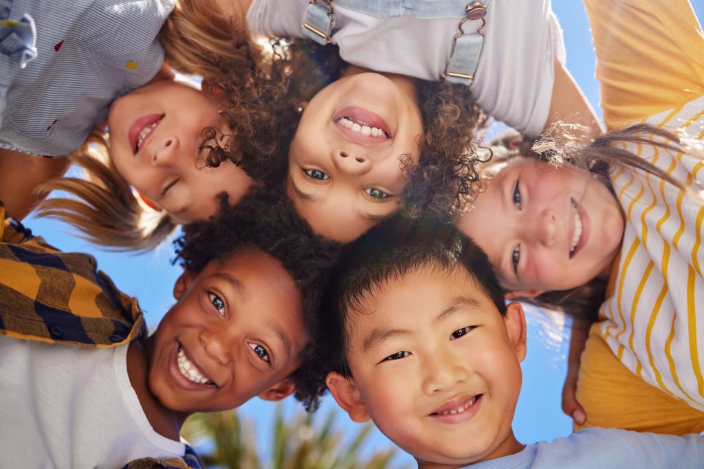 group of kids smiling down at camera