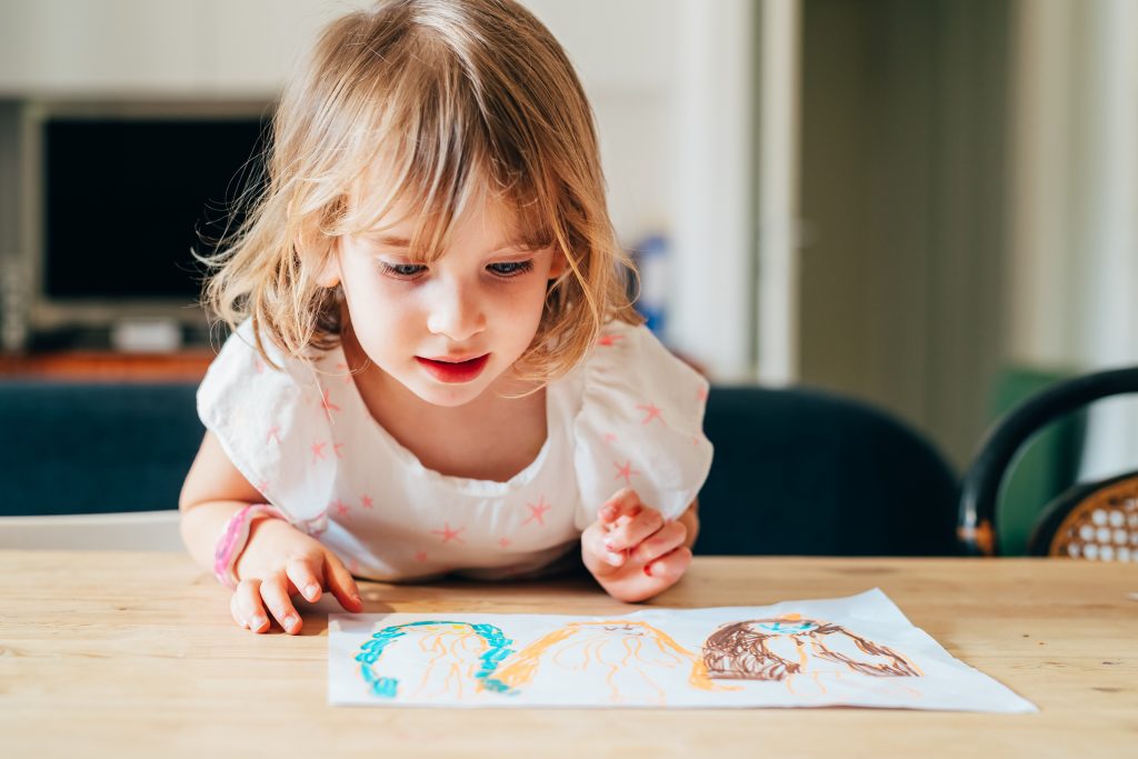 young girl looking at picture
