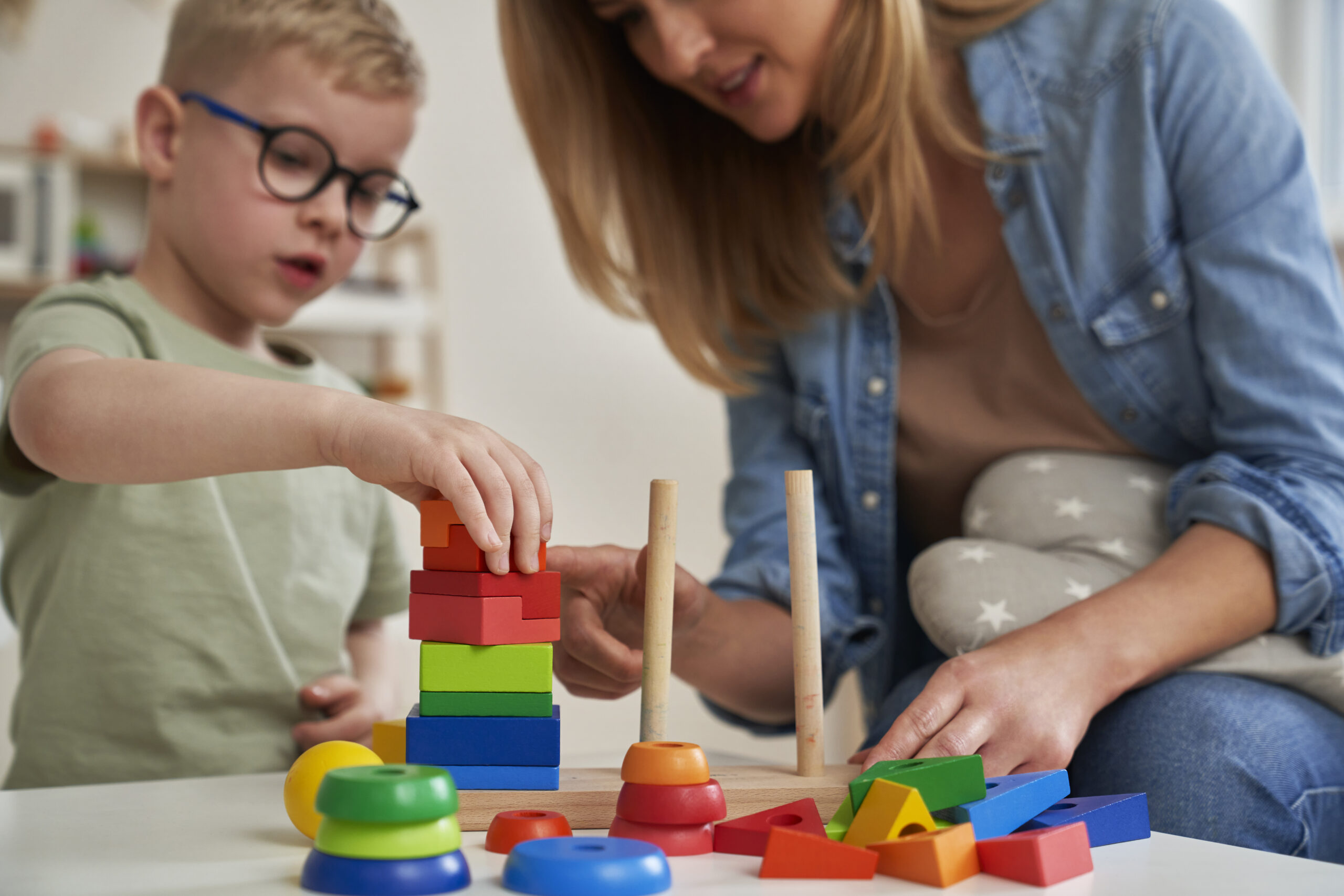 child and parent playing with educational toy