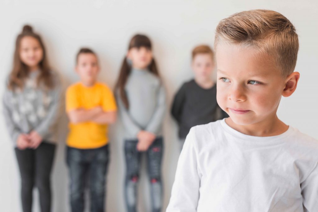 young boy with group of kids in the background