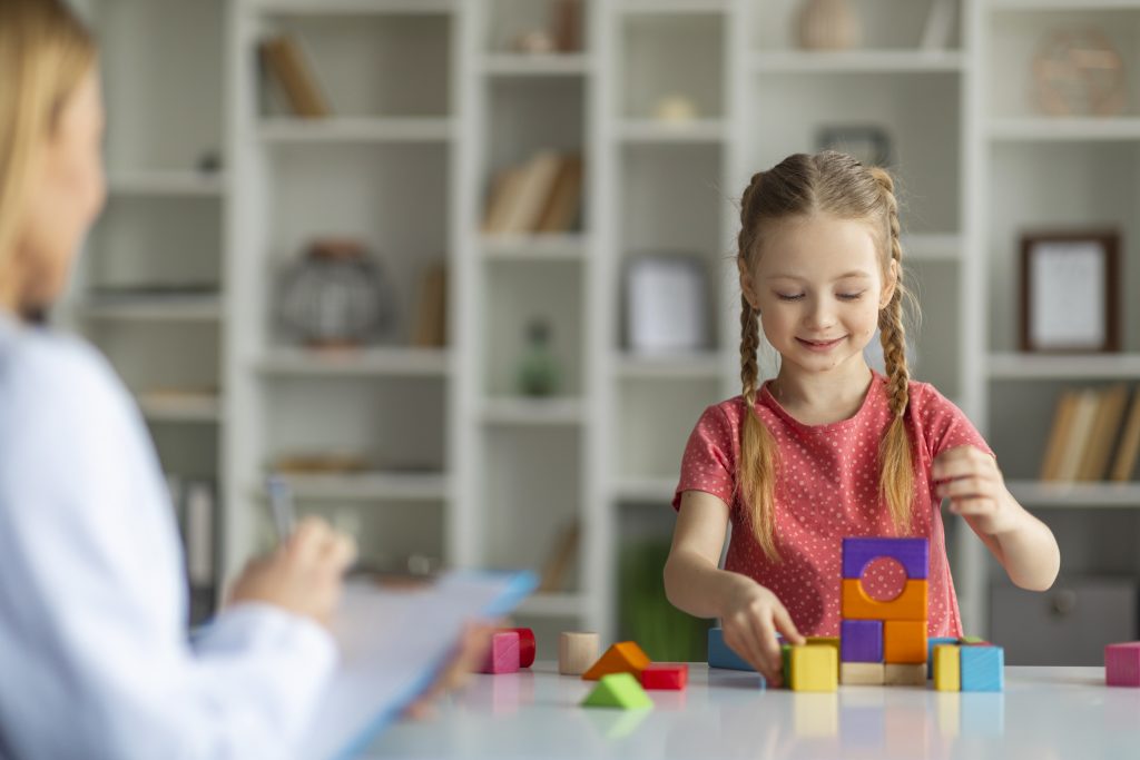 girl building pyramids from blocks
