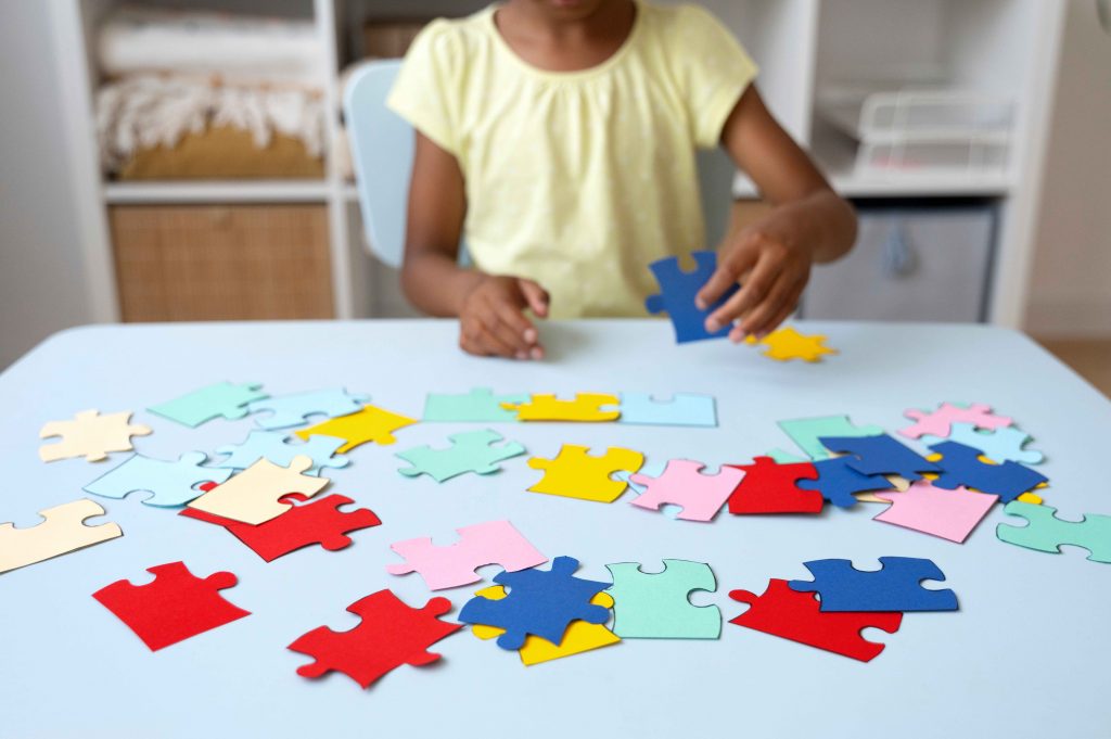 girl building a puzzle on the table