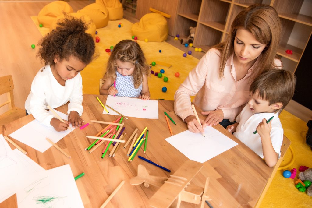 tutor and multicultural group of children