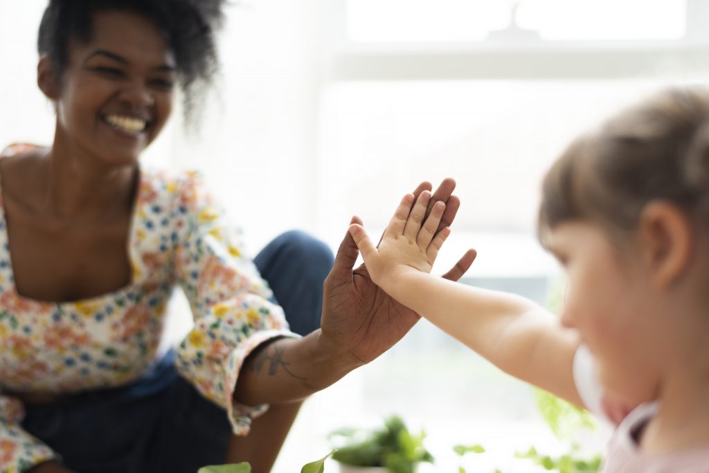 Child and therapist high-five