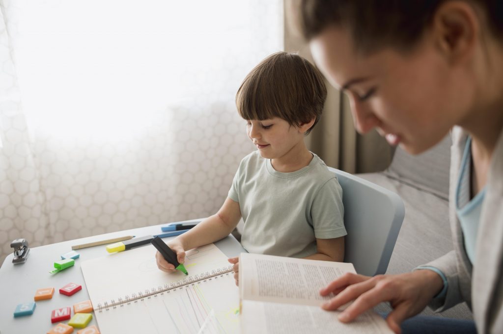 side view of child and tutor at home