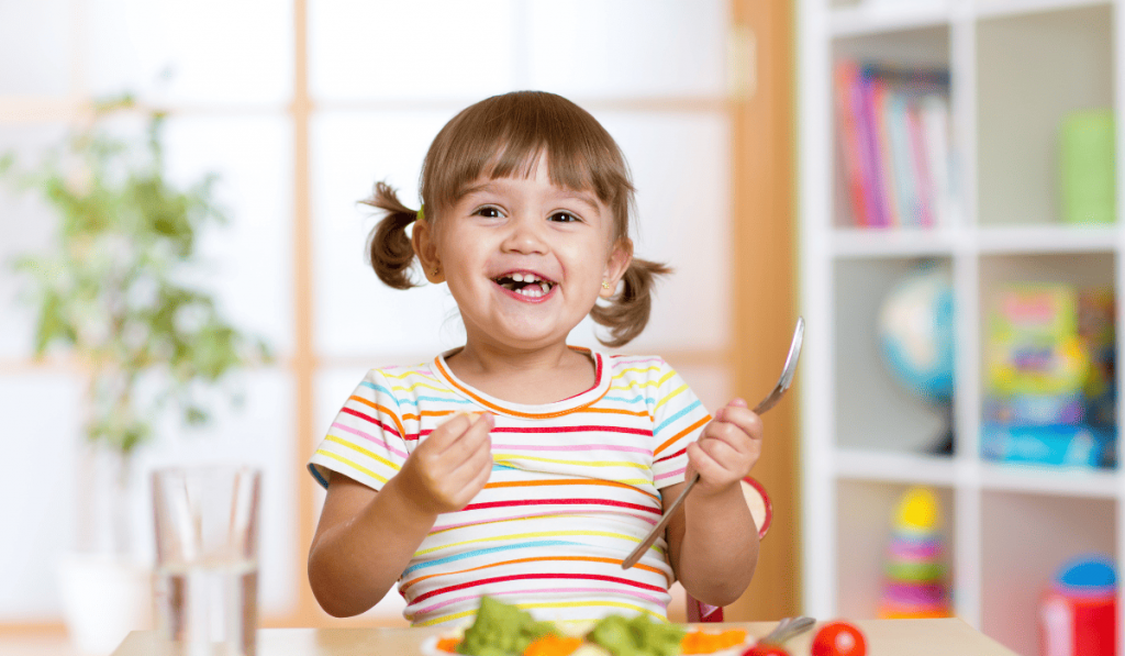 Smiling toddler while eating