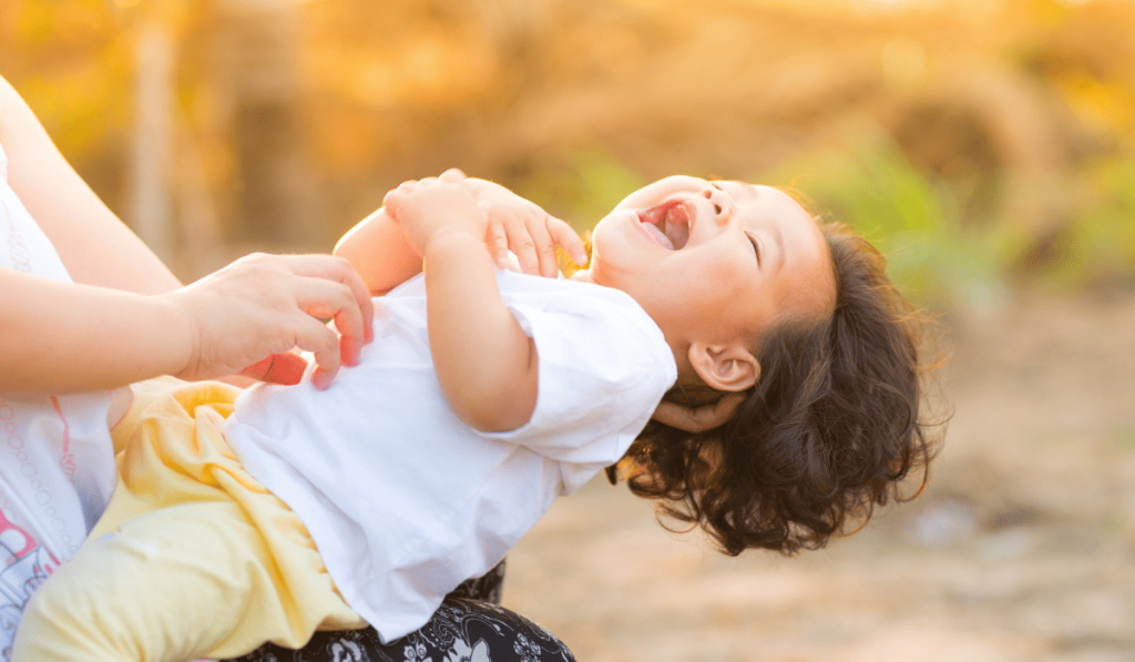 Child having a good laugh while playing