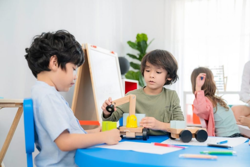 Children playing together in class