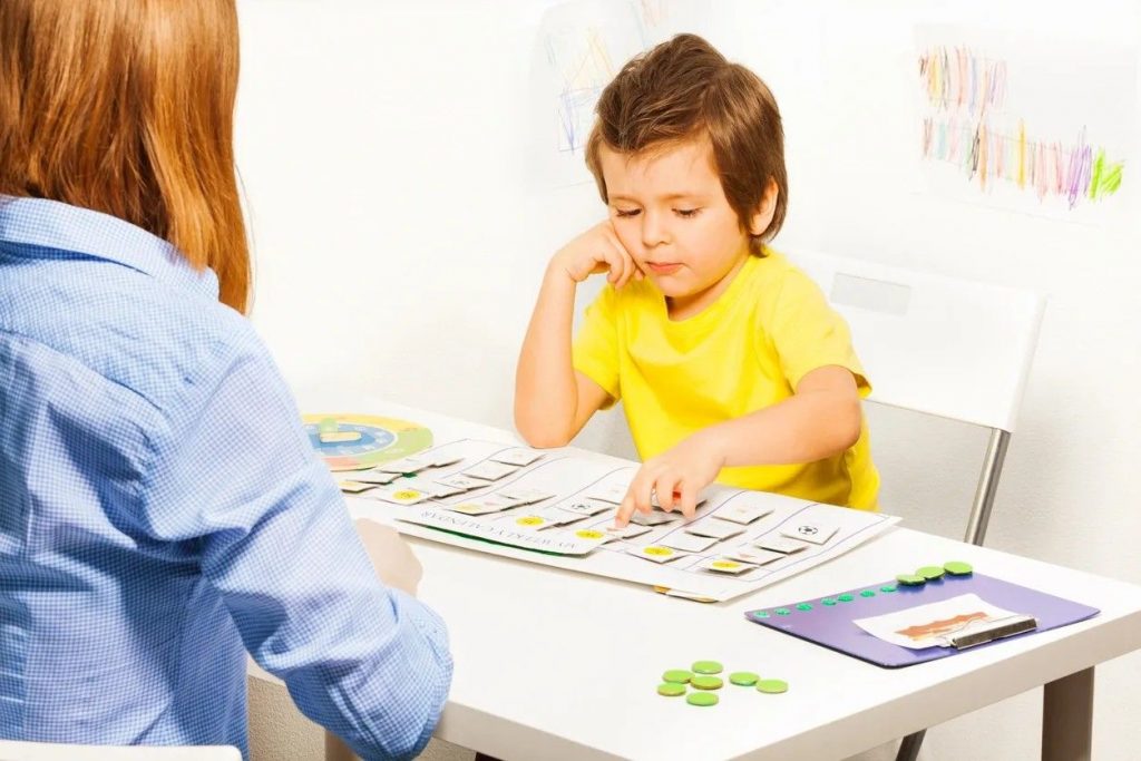 boy working with cards during therapy