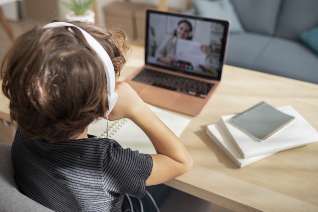 Child taking online lesson at a laptop