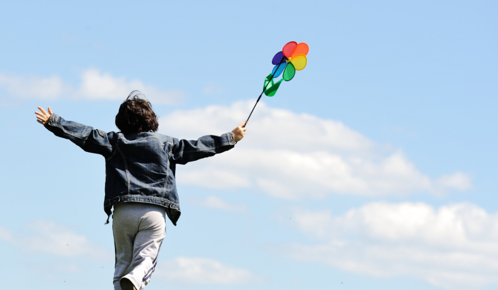 Child running with flower windmill