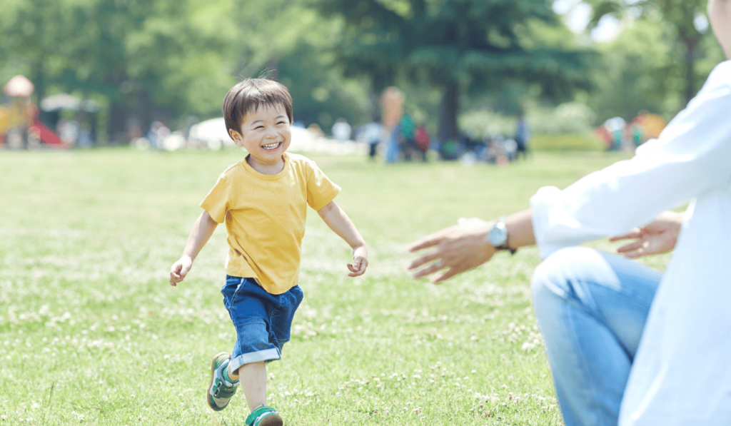 young boy running to adult
