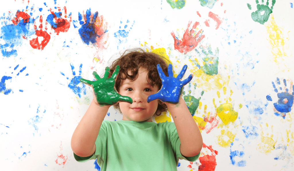 Young child with painted hands