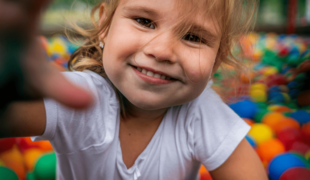 girls with smiling face reaching for the camera