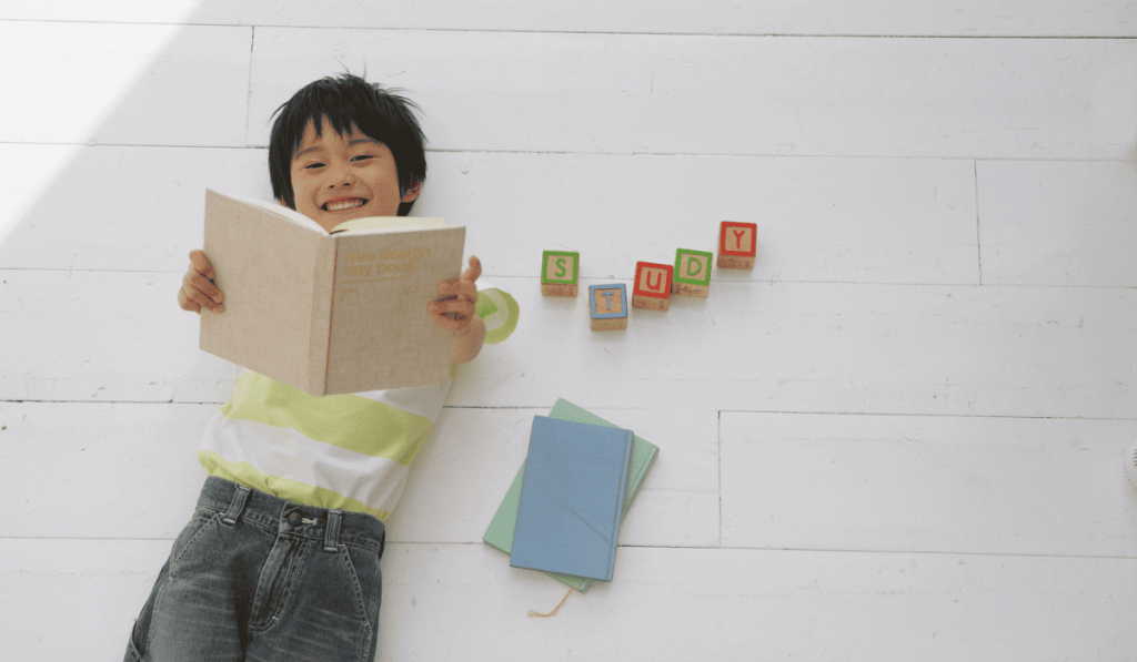 Child reading and smiling