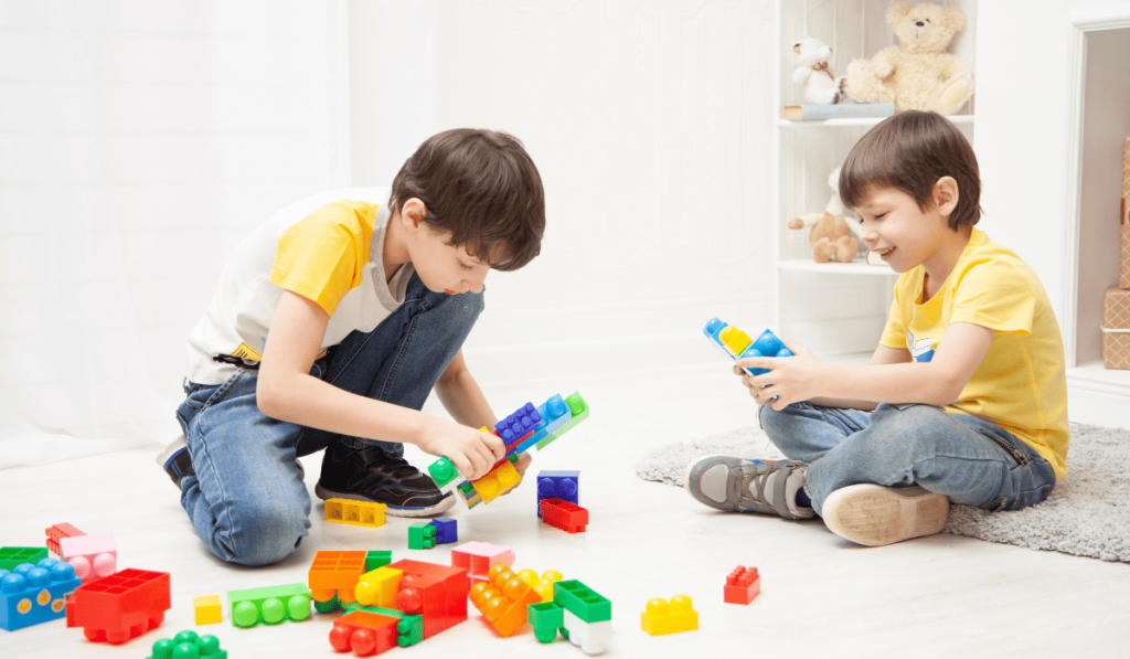 siblings playing with building blogs